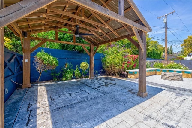 exterior space featuring a fenced backyard, a pool, a gazebo, and a patio area