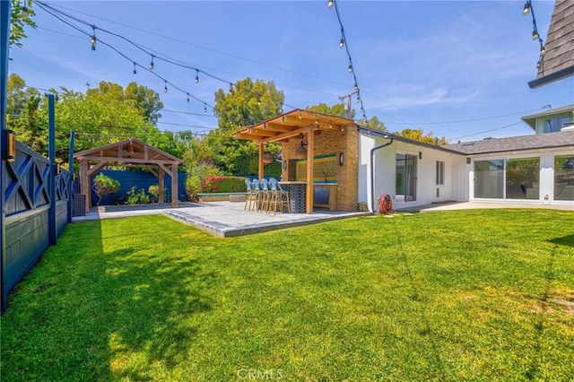 view of yard featuring a gazebo, a patio area, and a fenced backyard