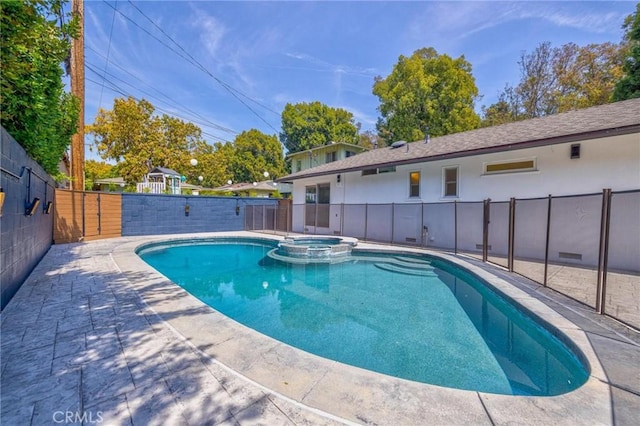 view of pool featuring fence, a patio area, and a pool with connected hot tub