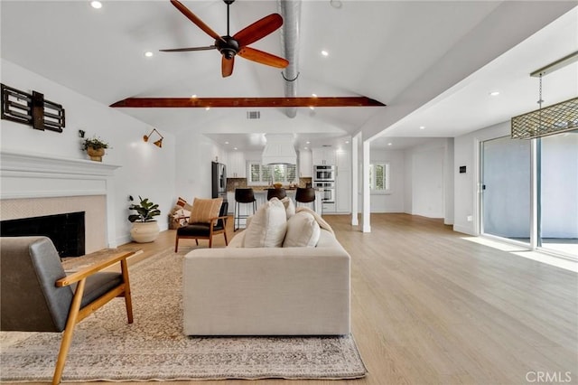 living area with a fireplace, light wood-style flooring, ceiling fan, and recessed lighting