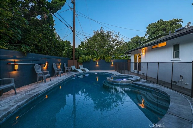 view of swimming pool with a pool with connected hot tub, a patio, and a fenced backyard