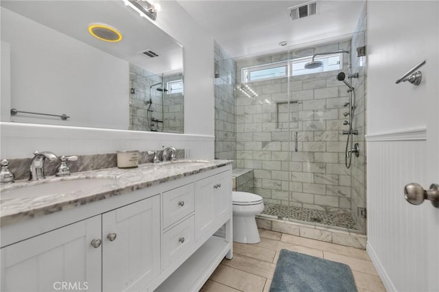 bathroom with a shower stall, visible vents, and a sink