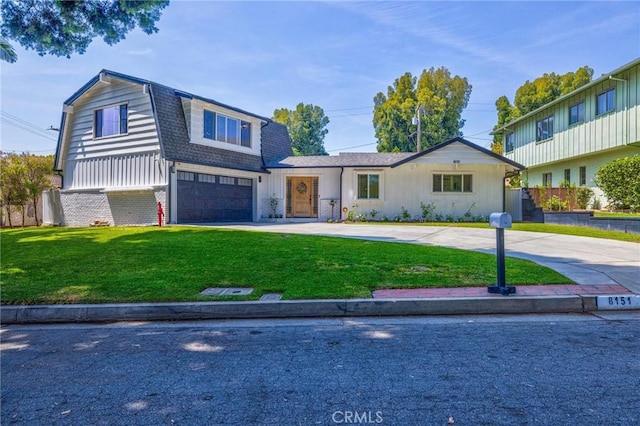 view of front of property with a gambrel roof, curved driveway, an attached garage, a front yard, and roof with shingles