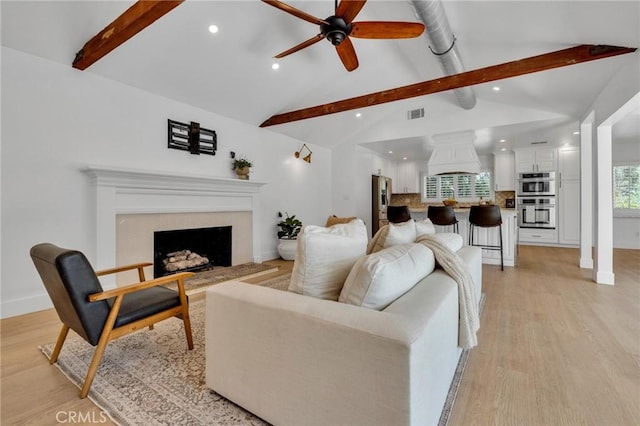 living area with recessed lighting, a fireplace, light wood finished floors, and ceiling fan
