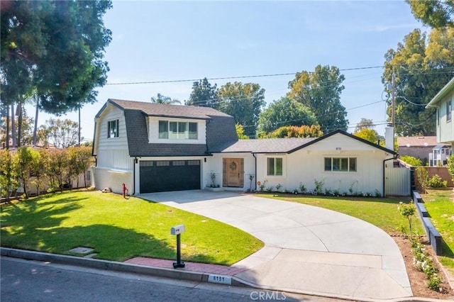 view of front facade featuring an attached garage, a front lawn, driveway, and roof with shingles