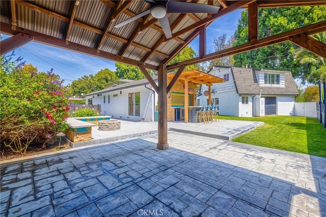 view of patio / terrace with a fire pit, outdoor dry bar, a ceiling fan, and a fenced backyard