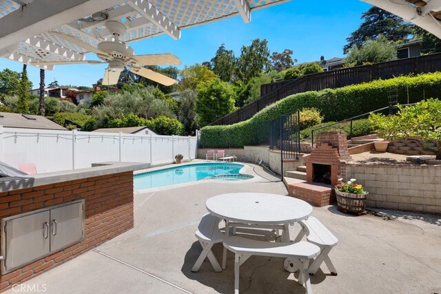 view of swimming pool featuring a fenced in pool, a fenced backyard, a pergola, a patio area, and an outdoor brick fireplace