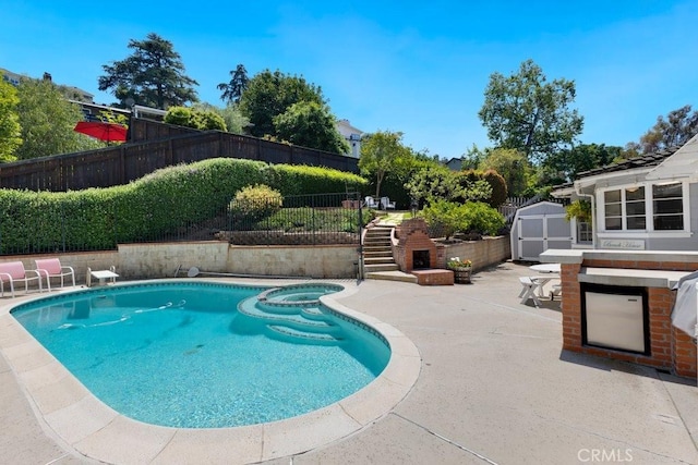 view of swimming pool with a storage shed, an outbuilding, a fenced backyard, a pool with connected hot tub, and a patio