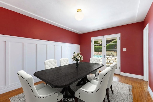 dining space with light wood-style floors and baseboards