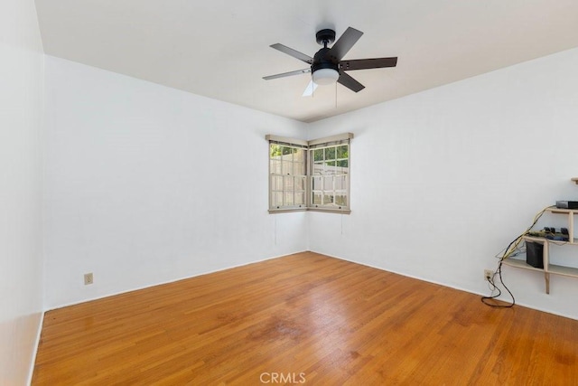 empty room featuring a ceiling fan and wood finished floors
