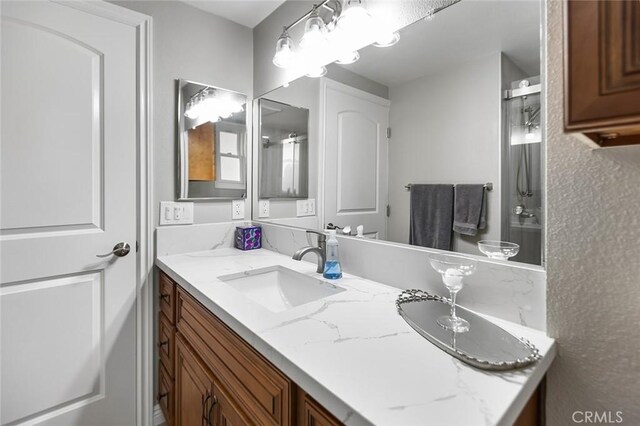 114 Via Estrada Unit B, Laguna Woods, CA 92637 - bathroom featuring a shower with shower door and vanity