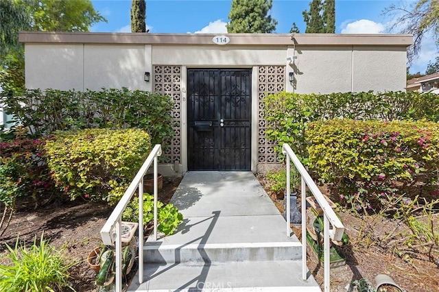 114 Via Estrada Unit B, Laguna Woods, CA 92637 - doorway to property with stucco siding