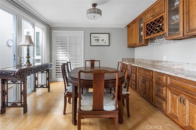 114 Via Estrada Unit B, Laguna Woods, CA 92637 - dining room with light wood finished floors, a dry bar, and ornamental molding