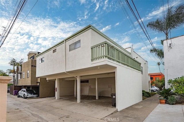 back of property featuring stucco siding and a balcony