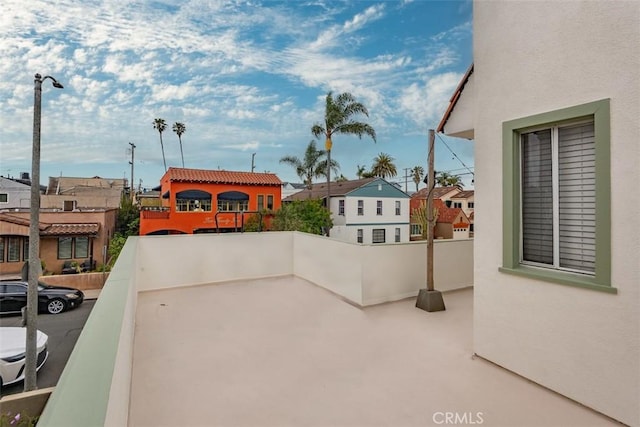 view of patio with a residential view and a balcony