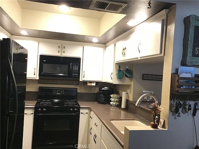 13919 Arthur Ave Unit 22, Paramount, CA 90723 - kitchen featuring black appliances, a sink, white cabinets, and visible vents