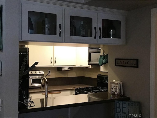 13919 Arthur Ave Unit 22, Paramount, CA 90723 - kitchen with a toaster, black appliances, and dark countertops