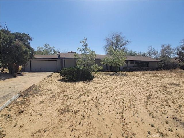ranch-style home featuring driveway and a garage