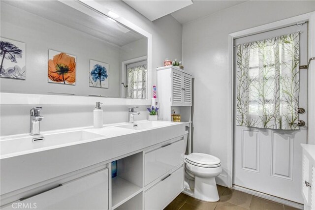 7293 Cirrus Way, West Hills, CA 91307 - bathroom featuring toilet, double vanity, and tile patterned floors