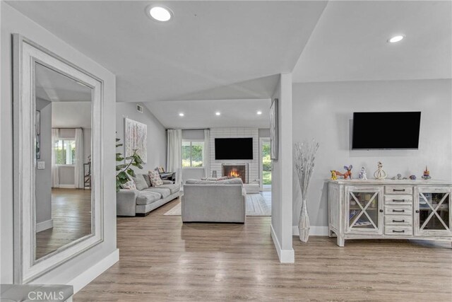 7293 Cirrus Way, West Hills, CA 91307 - living area featuring light wood-style flooring, baseboards, plenty of natural light, recessed lighting, and vaulted ceiling
