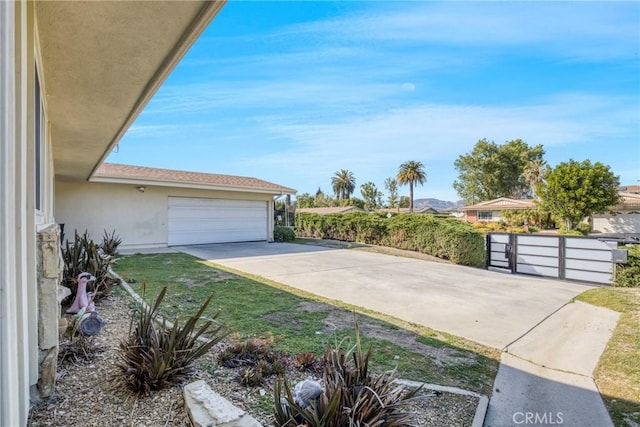 7293 Cirrus Way, West Hills, CA 91307 - view of side of home with stucco siding, driveway, and a garage