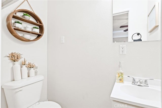 half bathroom with toilet and vanity