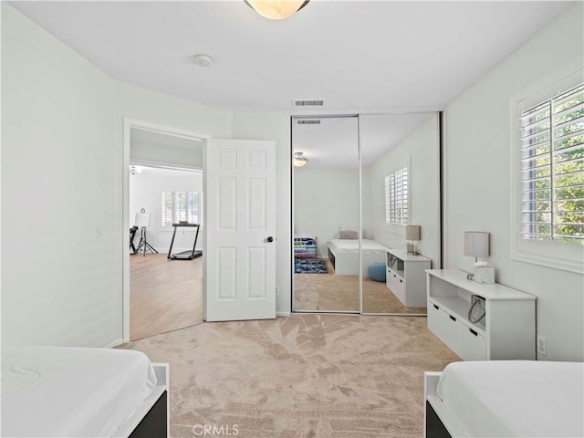 25626 Moore Ln, Stevenson Ranch, CA 91381 - bedroom with multiple windows, light colored carpet, and a closet