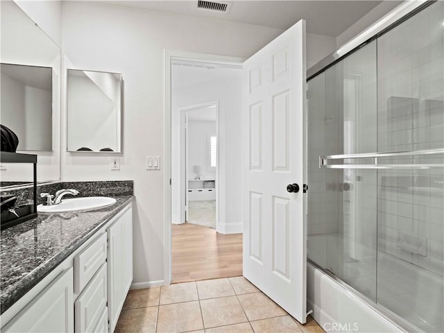 25626 Moore Ln, Stevenson Ranch, CA 91381 - full bath with tile patterned flooring, vanity, baseboards, and combined bath / shower with glass door
