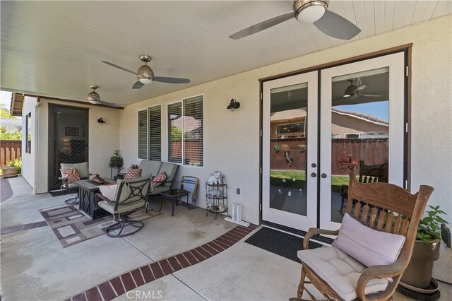 view of patio / terrace featuring french doors, a ceiling fan, and fence