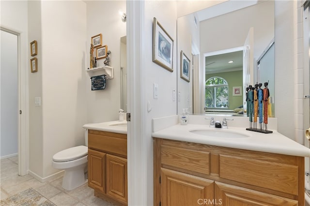 full bathroom with two vanities, tile patterned floors, a sink, and toilet