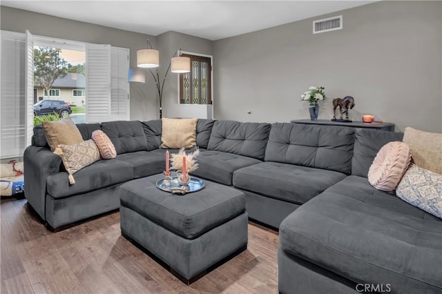 living room featuring visible vents and wood finished floors