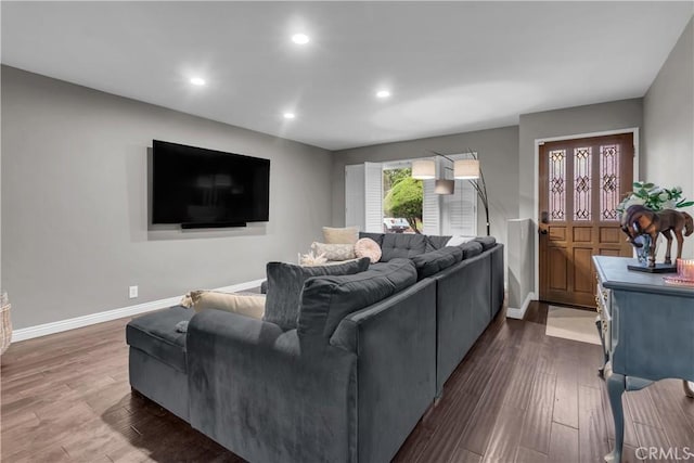 living area with recessed lighting, dark wood-style flooring, and baseboards