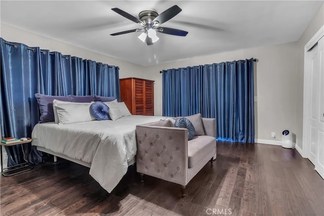 bedroom featuring a ceiling fan, a closet, wood finished floors, and baseboards