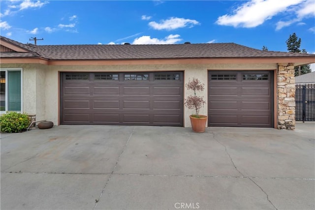 garage featuring concrete driveway