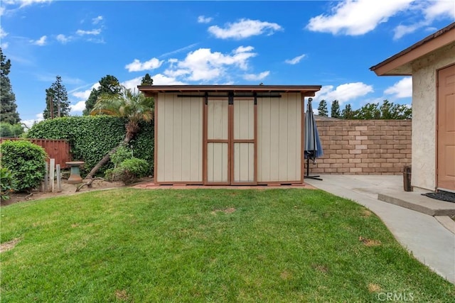 view of shed with a fenced backyard