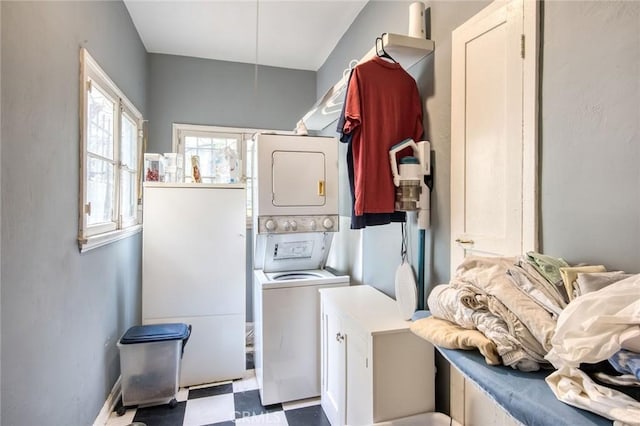 4912 Edgewood Pl, Los Angeles, CA 90019 - washroom with cabinet space, stacked washer and dryer, and tile patterned floors