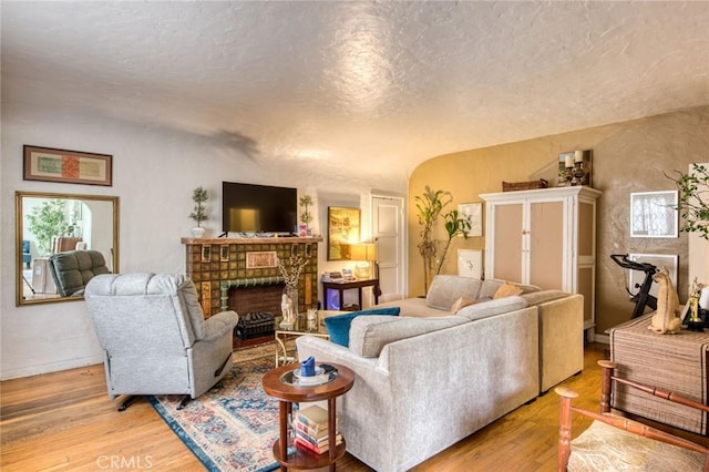 4912 Edgewood Pl, Los Angeles, CA 90019 - living room with a fireplace, wood finished floors, and a wealth of natural light