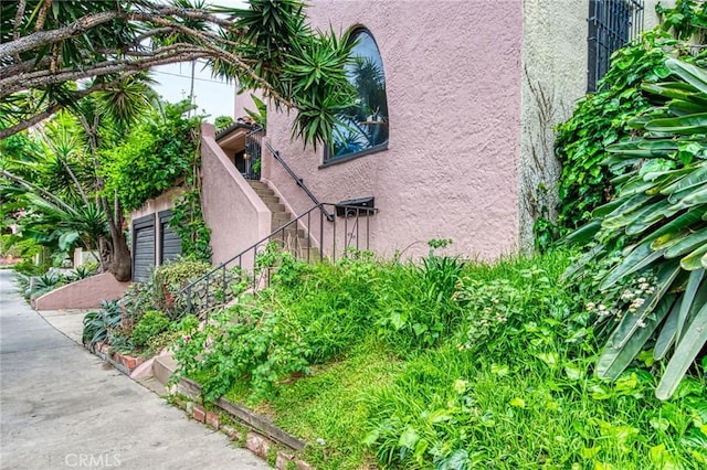 4912 Edgewood Pl, Los Angeles, CA 90019 - view of side of home with stairs and stucco siding