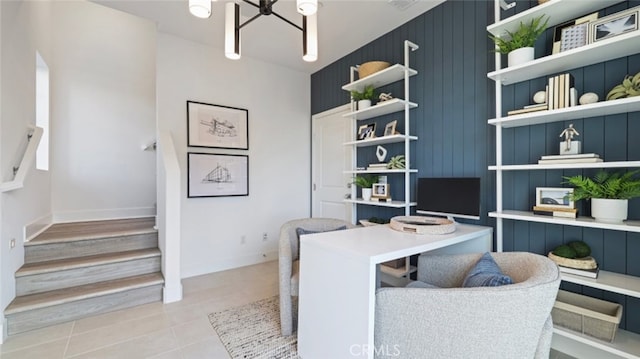 home office with a chandelier, baseboards, and light tile patterned floors