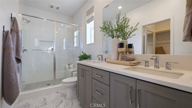 bathroom with toilet, a sink, double vanity, and a stall shower