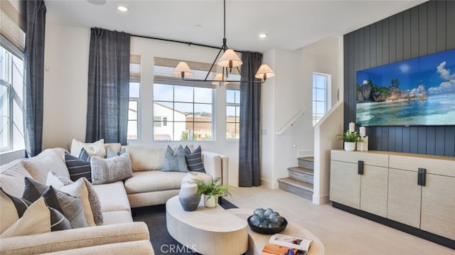 living room featuring a chandelier, stairway, a healthy amount of sunlight, and recessed lighting