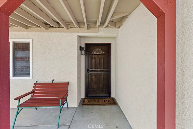 doorway to property with stucco siding