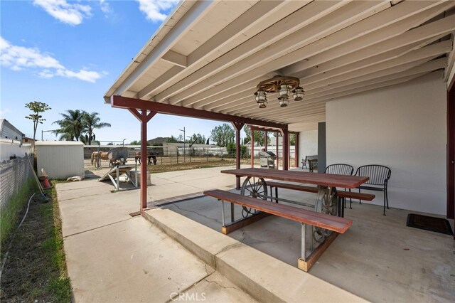 view of patio featuring grilling area, a fenced backyard, and outdoor dining space