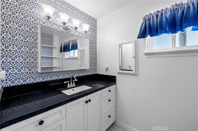bathroom with baseboards and vanity