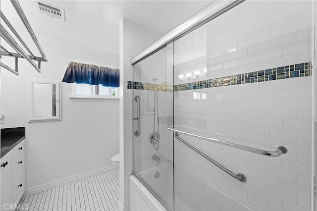 bathroom featuring combined bath / shower with glass door, visible vents, toilet, vanity, and baseboards