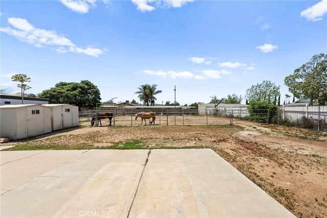 view of patio / terrace featuring an outbuilding and fence