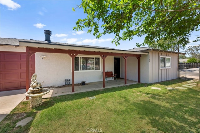 ranch-style house featuring board and batten siding, a front lawn, fence, and a patio