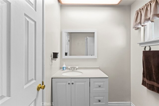 bathroom with baseboards and vanity
