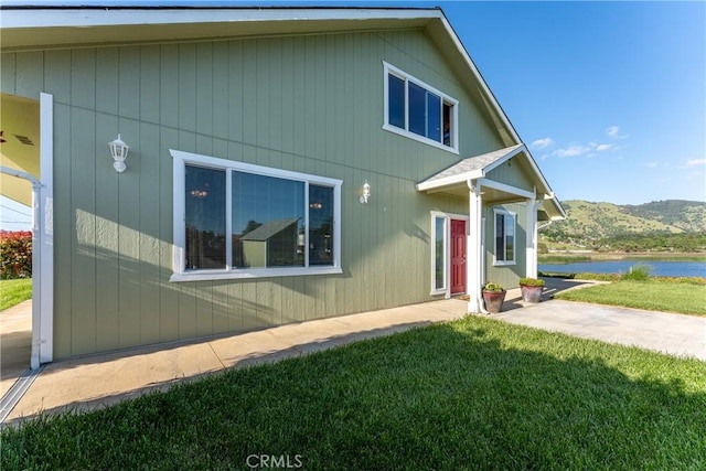bungalow-style home with a front lawn and a water view