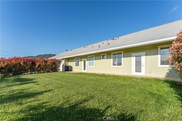 rear view of house with a yard